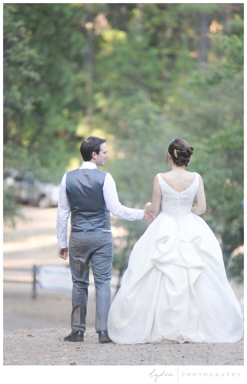 Bride and groom walking for a garden wedding at Roth Estate, in Grass Valley, California 