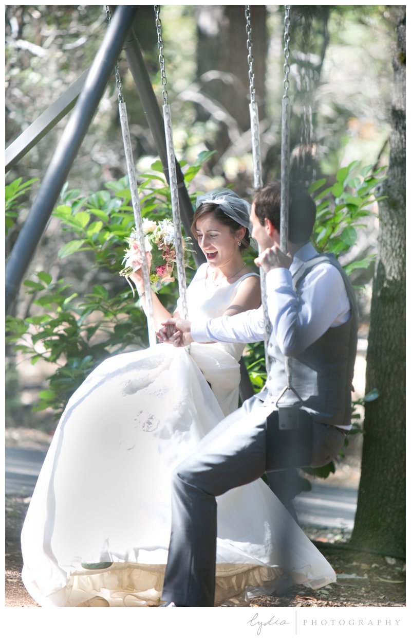 Bride and groom on the swings for a garden wedding at Roth Estate, in Grass Valley, California 