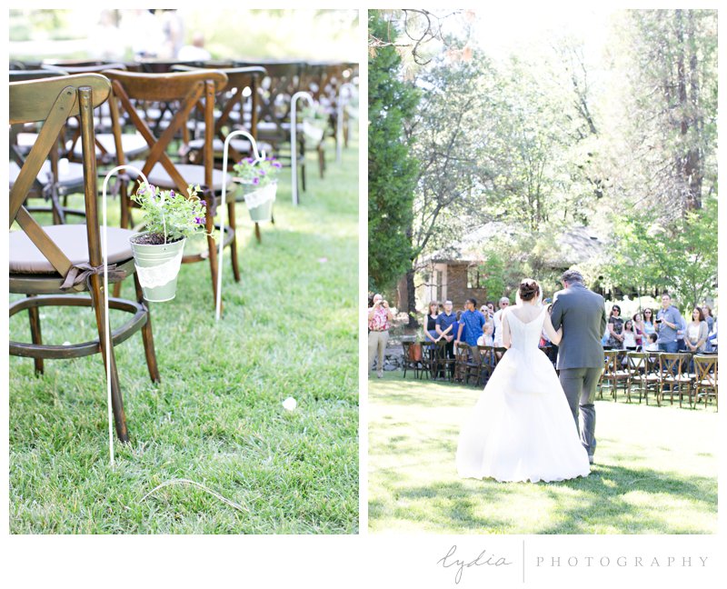 Wooden chairs and bride coming down the aisle for a garden wedding at Roth Estate, in Grass Valley, California 