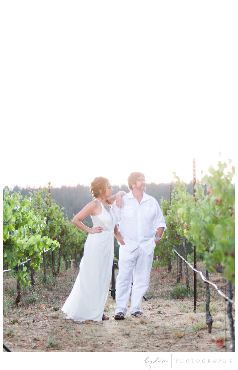 Bride and groom at the sunset in the vineyard for a vintage wedding at Lucchesi Vineyards in Grass Valley, California.
