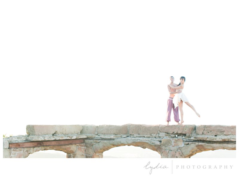 Ballerina and daseur dancing on the wall for ballet pictures at Knapp's Castle in Santa Barbara, California.