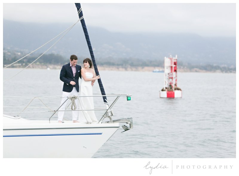 Bride and groom on the front of the boat posing like the Titanic for a nautical wedding styled inspiration portraits in Santa Barbara, California.