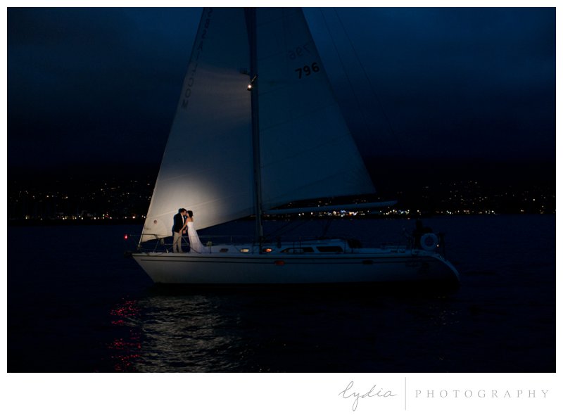 Bride and groom on the boat at night with a spotlight for a nautical wedding styled inspiration portraits in Santa Barbara, California.