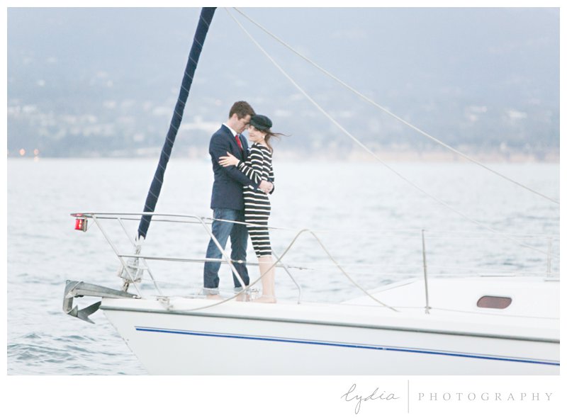 Bride and groom on the front of the boat for a nautical engagement styled inspiration portraits in Santa Barbara, California.