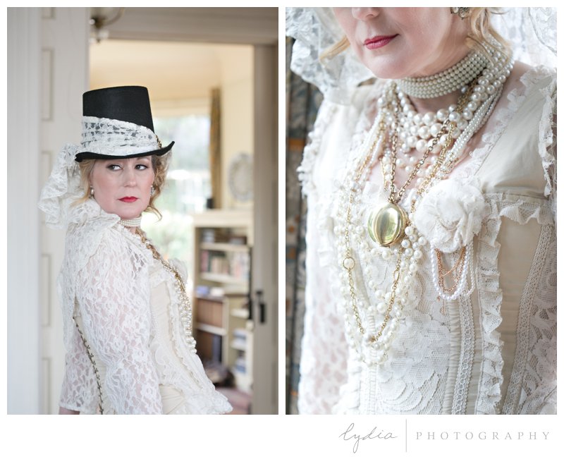 Chris Enns wearing pearls and a gold locket for western author pictures at a Victorian house in Grass Valley, California.