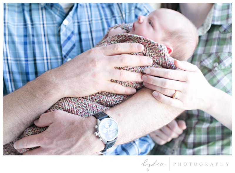 Baby being held by parents for a lifestyle newborn portraits in Napa, California