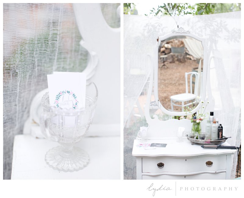 A makeup table and invitations for a forest barn wedding in Grass Valley, California.
