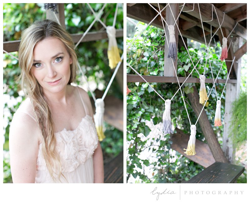 Bride under a decorated wooden arch at southwest boho wedding inspiration in Grass Valley, California.