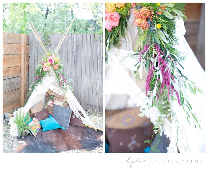 Flowers on a tepee decoration at southwest boho wedding inspiration in Grass Valley, California.