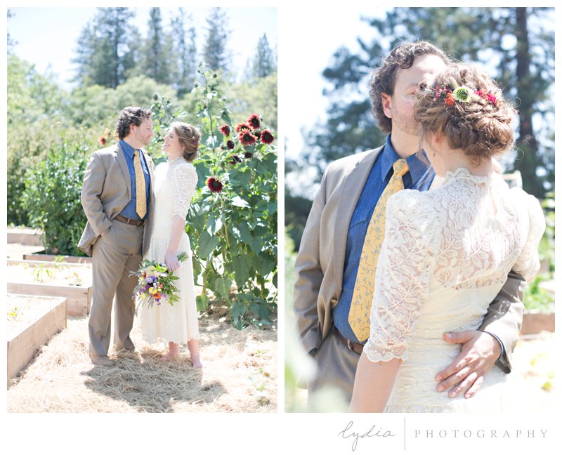Bride and groom in the garden with sunflowers at rustic garden wedding in Chicago Park, California.