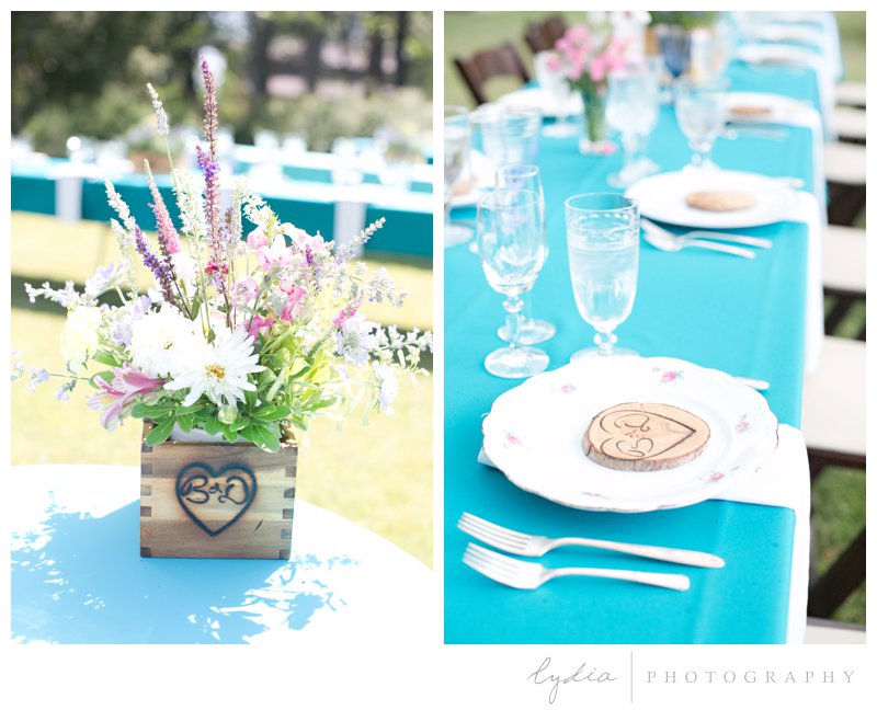 Table setting with vintage plates and glasses at rustic garden wedding in Chicago Park, California.