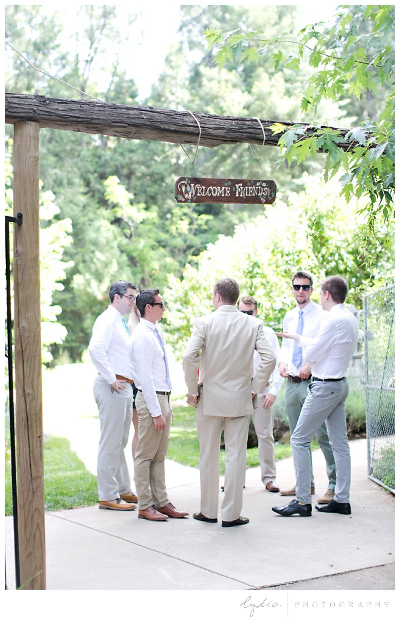Groom and groomsmen talking with each other at Harmony Ridge Lodge wedding in Grass Valley, California.