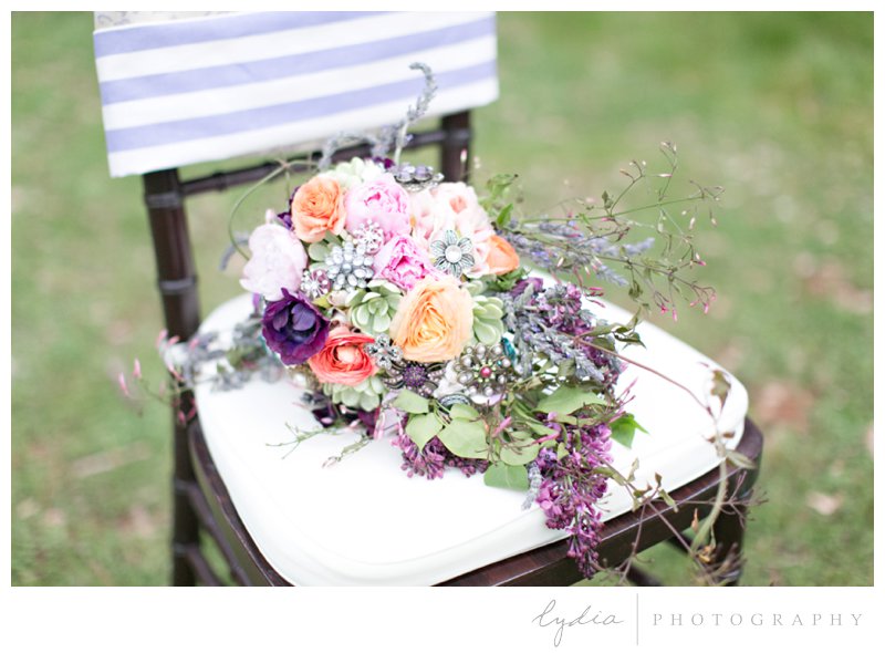 Bridal bouquet with antique broaches at French Countryside wedding at North Star House in Grass Valley, California.
