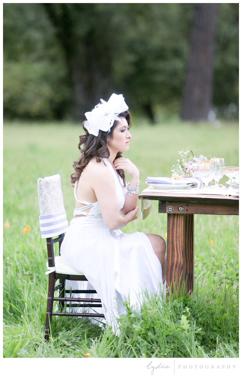Bride sitting at table at French Country wedding at North Star House in Grass Valley, California.