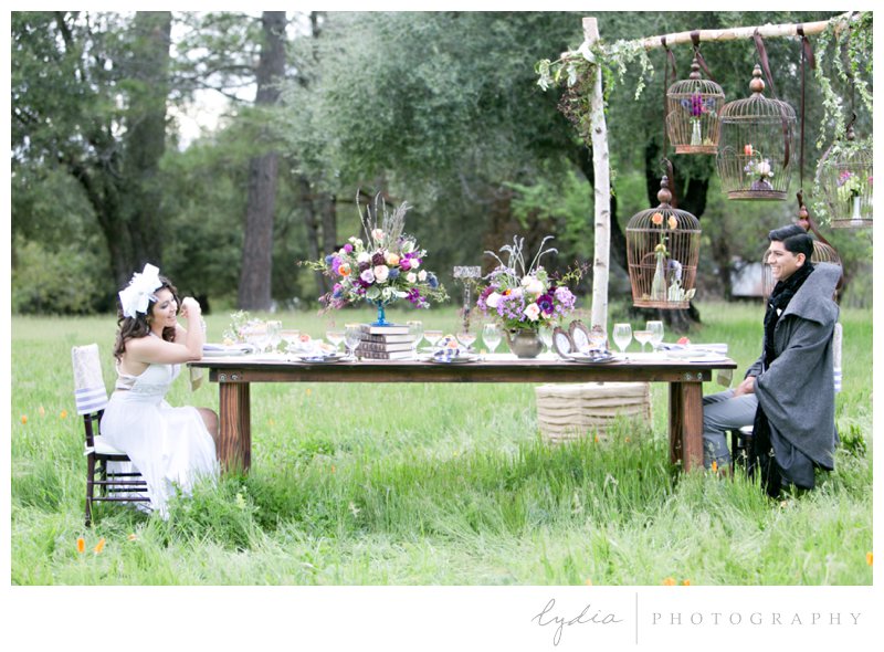 European bride and groom at reception setting in orchard at French Country wedding at North Star House in Grass Valley, California.