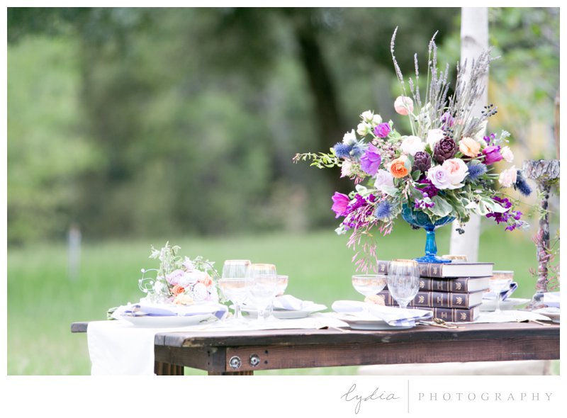 Reception table setting on barnwood table at French Countryside wedding at North Star House in Grass Valley, California.