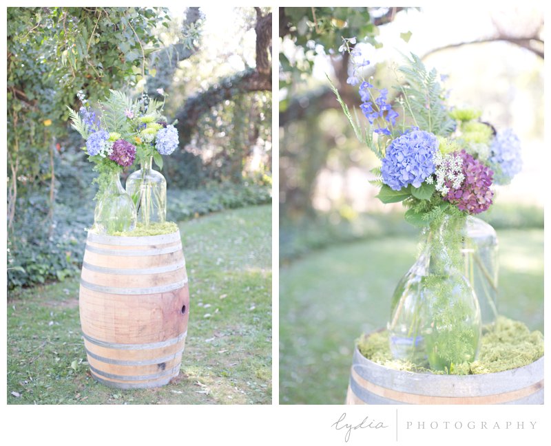 Flowers on a barrel at a barn at Squirrel Creek Ranch wedding in Grass Valley, California.