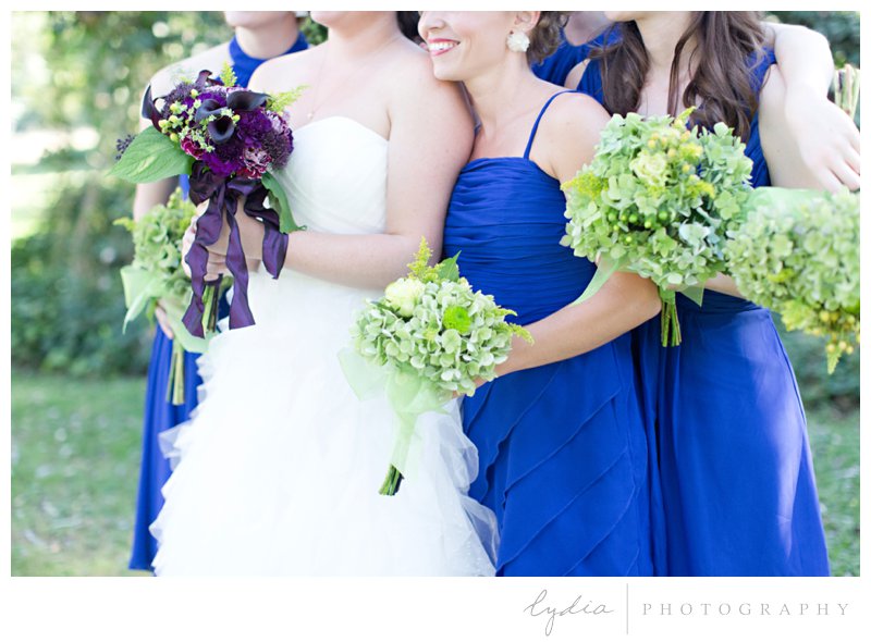 Bride and bridesmaids with bouquets at a barn wedding at Squirrel Creek Ranch in Grass Valley, California.