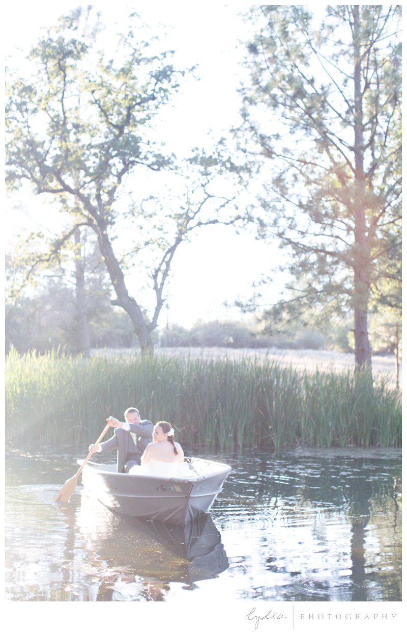 Groom rowing in with the bride at a barn wedding at Squirrel Creek Ranch in Grass Valley, California.