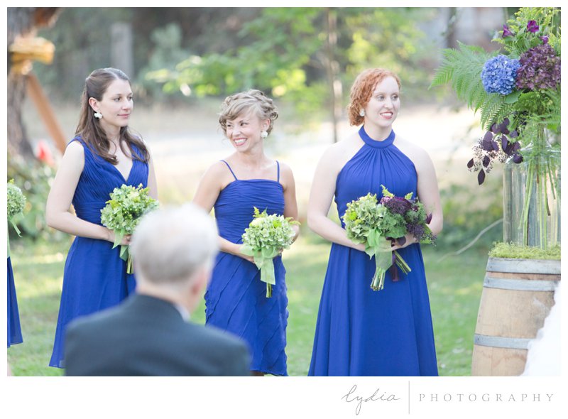 Bridesmaids with bouquets at a barn wedding at Squirrel Creek Ranch in Grass Valley, California.