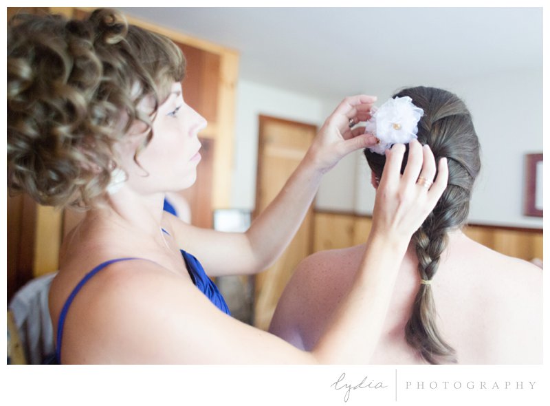 Bride geytting her hair done at a barn wedding at Squirrel Creek Ranch in Grass Valley, California.