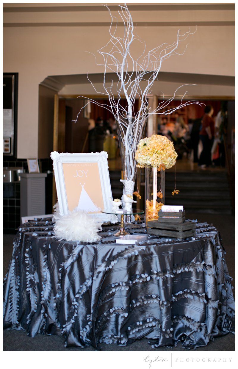Silk tablecloth, feathers, and birch branches at Veterans Hall Art Deco ombre wedding bridal show in Grass Valley, California.
