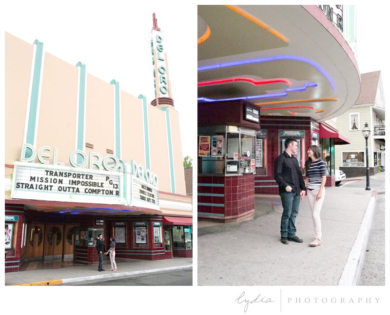 Bride and groom outside of Del Oro theater at engagement portrait session in downtown Grass Valley, California.