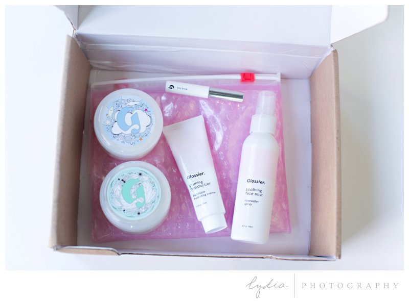 Review and unboxing of Glossier products by professional makeup artist in Grass Valley, California.