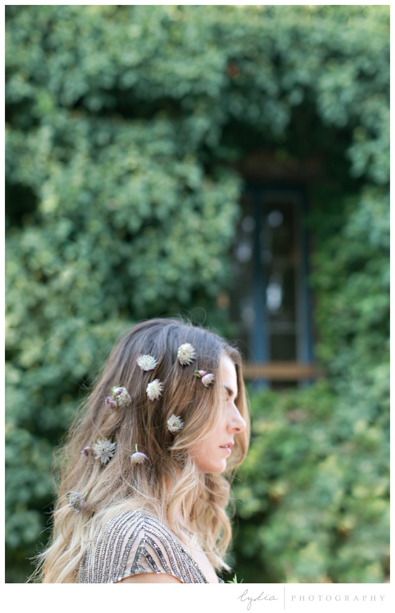 Bride with flowers in her hair at Old World Italy wedding at Miners Foundry in Nevada City, California.