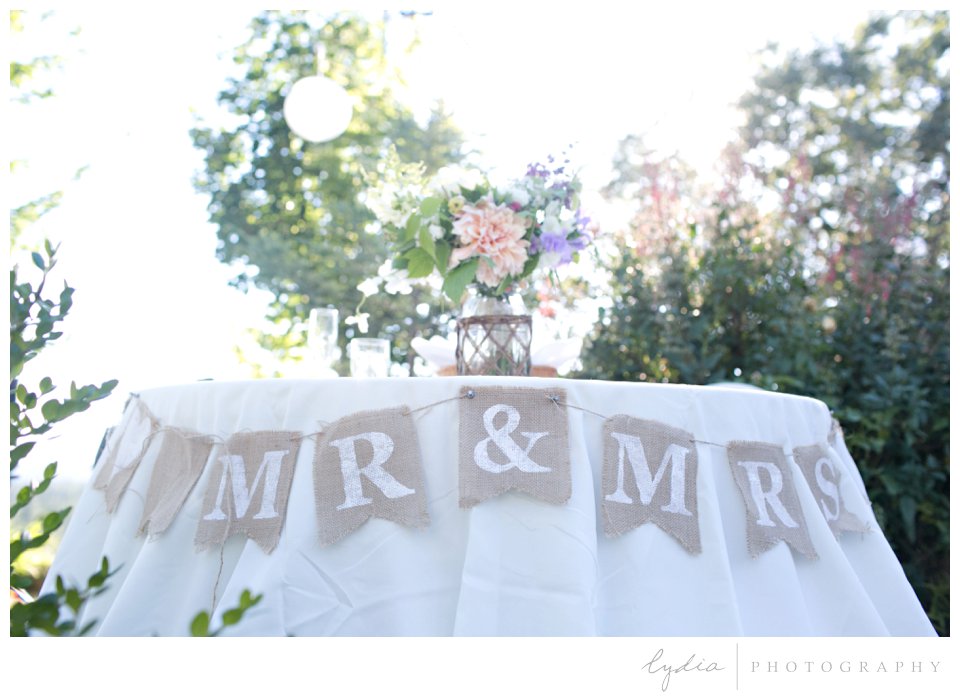 Handmade Mr. and Mrs. sign on sweetheart table at Lucchesi Vineyards wedding in Grass Valley, California.