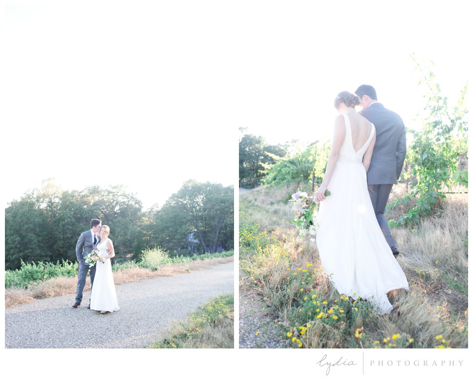 Bride and groom walking together at sunset at Lucchesi Vineyards wedding in Grass Valley, California.
