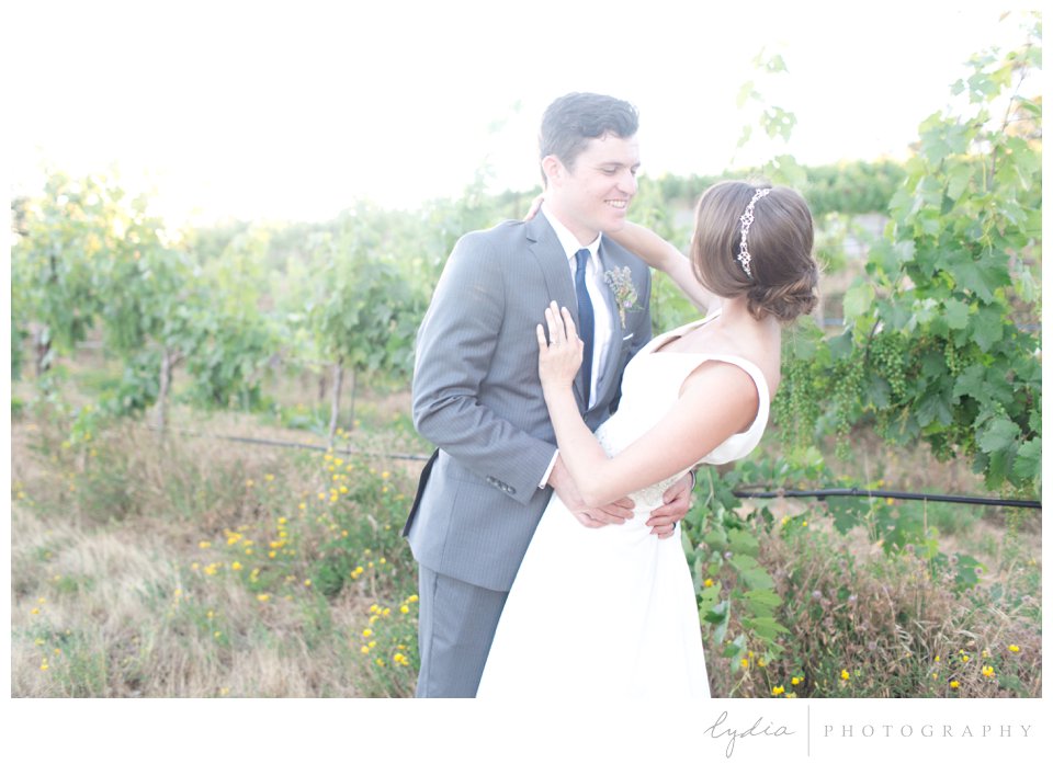 Bride and groom laughing at Lucchesi Vineyards wedding in Grass Valley, California.