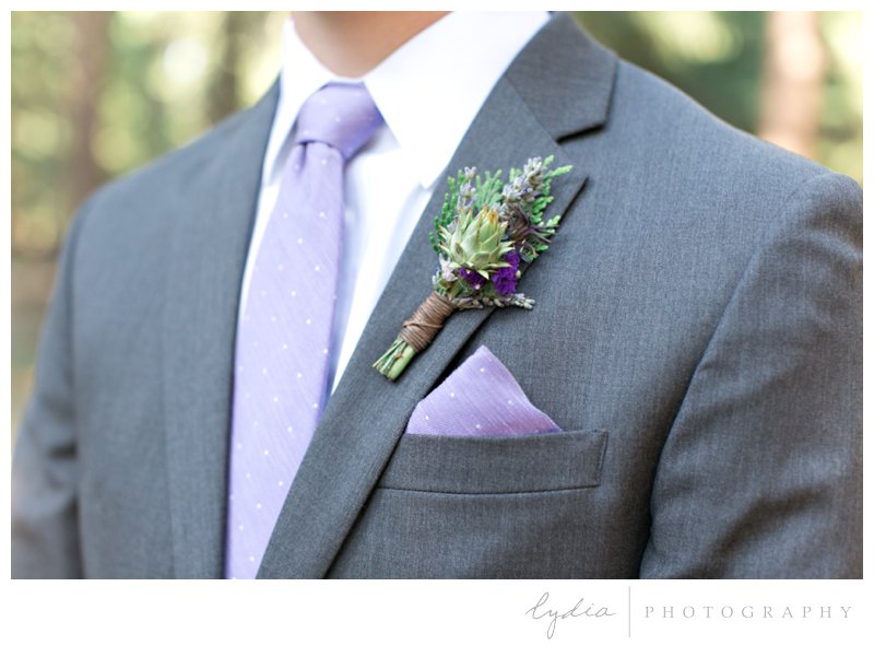 Groom wearing boutonniere in the Tahoe forest at Harmony Ridge Lodge in Nevada City, California.