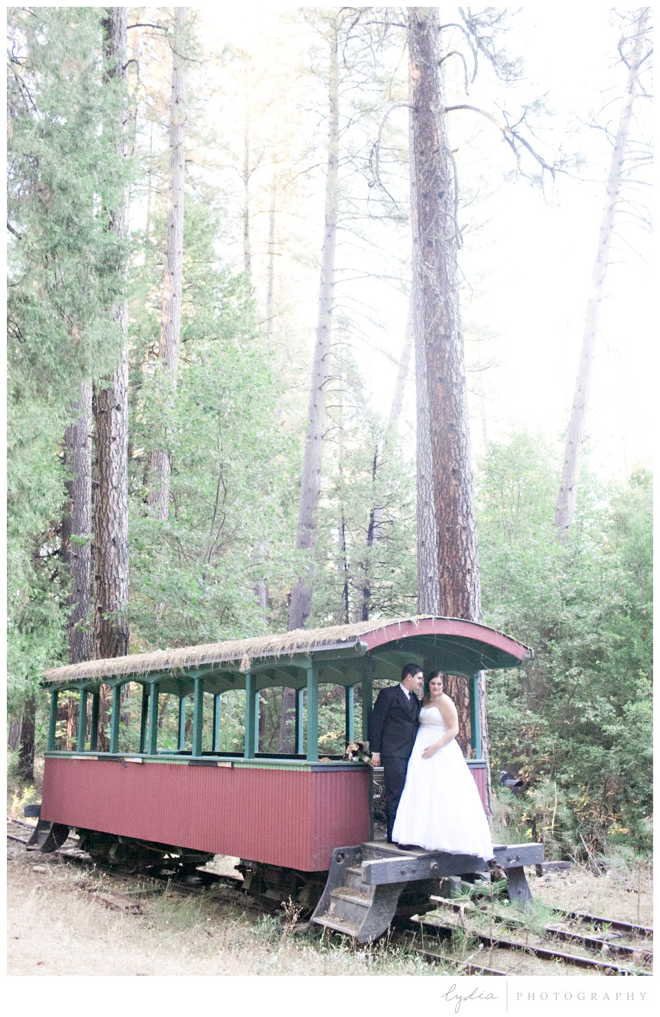 Bride and groom standing on train platform at Northern Queen Inn Wedding in Nevada City, California.