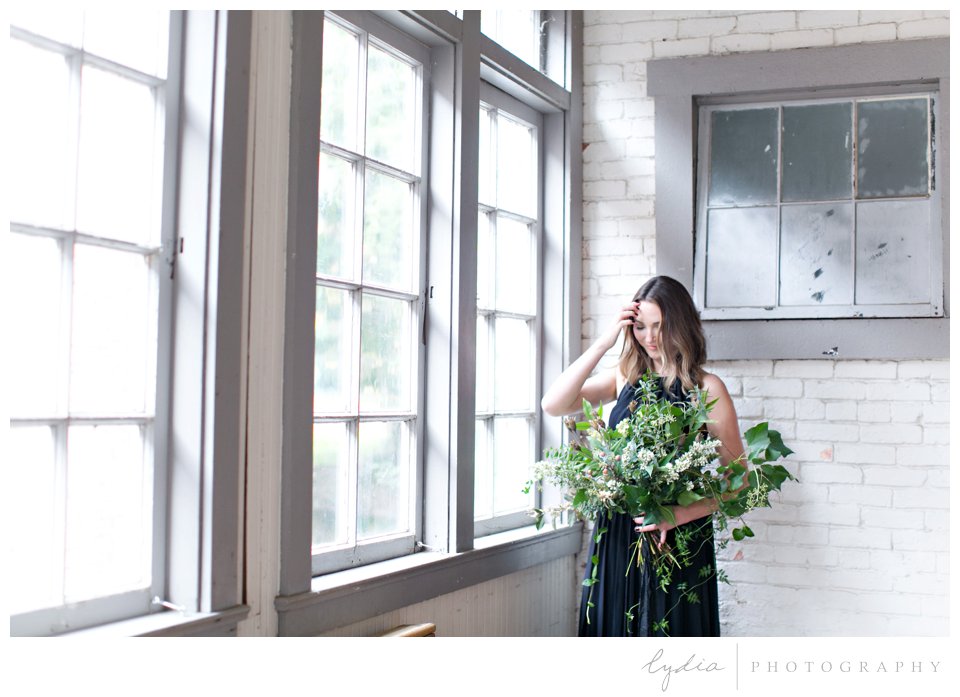 Bride by window at intimate elopement for European wedding styled inspiration.