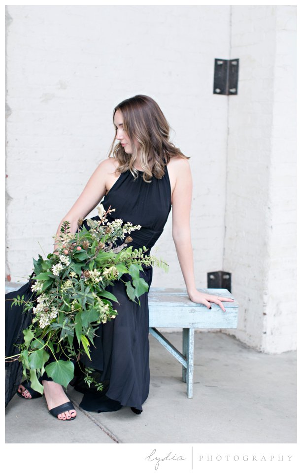 Bride in black dress with foraged bouquet at intimate elopement for European wedding styled inspiration.