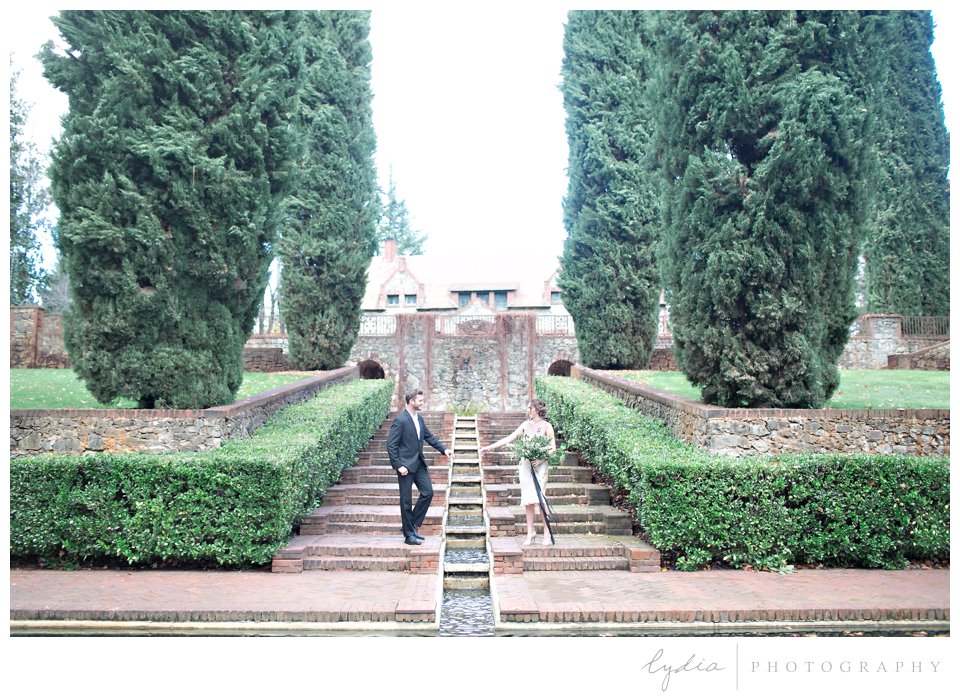 Bride and groom in gardens at intimate elopement for European wedding styled inspiration.