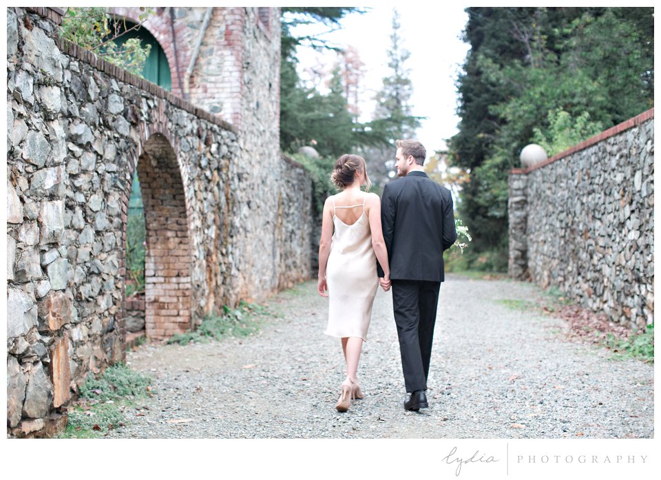Bride and groom walking at intimate elopement for European wedding styled inspiration.