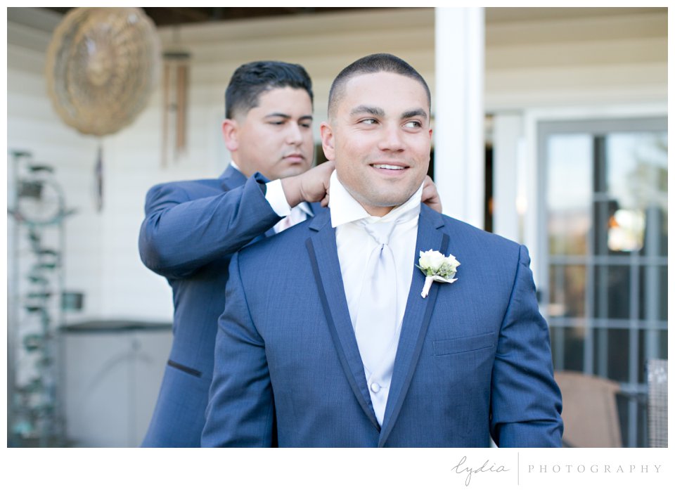 Groom tying tie at The Highlands Estate Wedding in Sonoma, California.