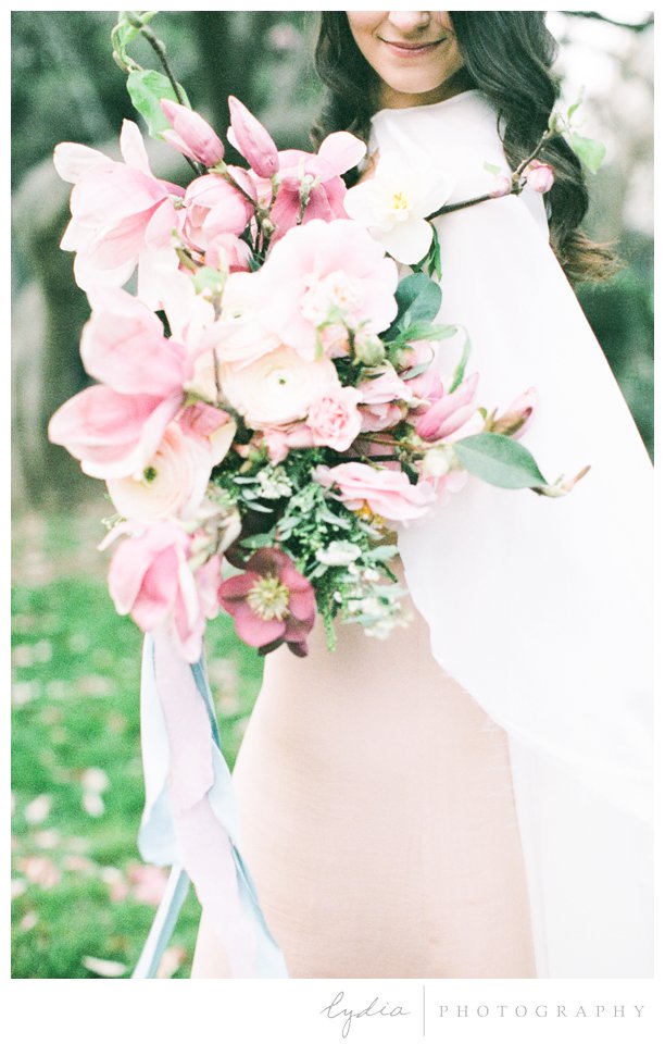 Bride holding bouquet at California capitol in film wedding photography.