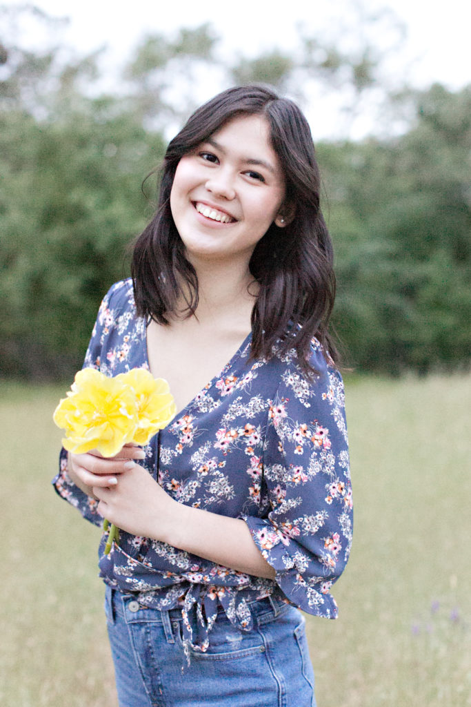 Girl smiling holding yellow tulips for Del Oro senior portraits
