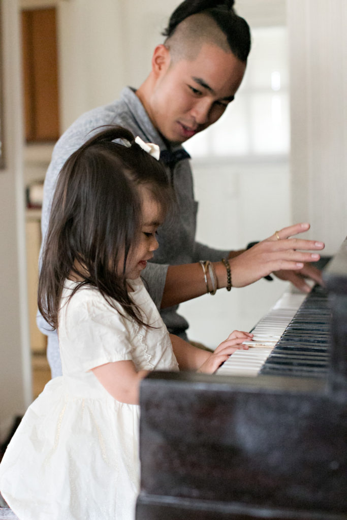 Uncle playing piano with niece at Sacramento lifestyle family portraits