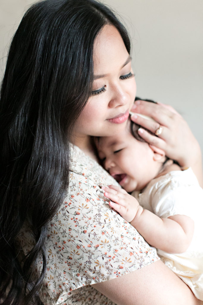 Mother holding baby daugher at Sacramento lifestyle family portraits