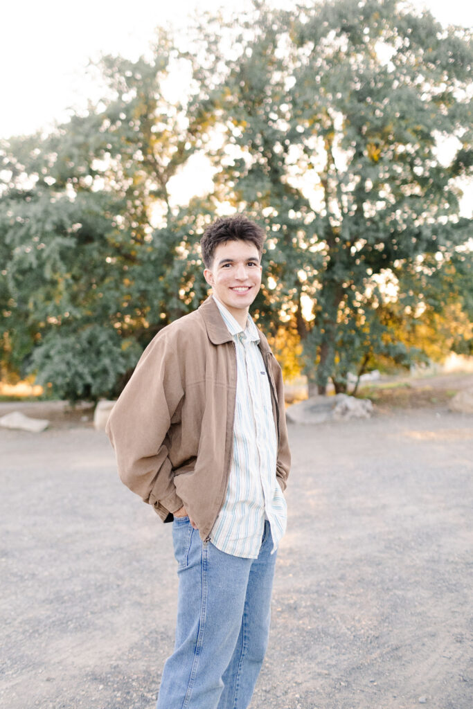 Young man wearing jacket at Roseville senior portrait session.